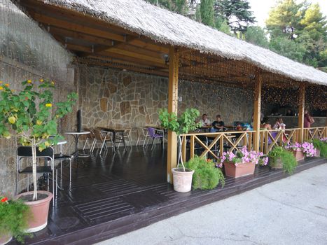 summer outdoor cafe near the square on a reed roof terrace