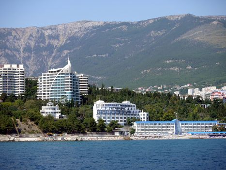 Luxury hotels with their own beaches near the sea on the background of high green mountains
