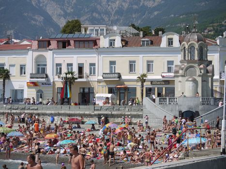 A beach where a lot of tourists and vacationers rest. For convenience near the beach there is a lot of different shops