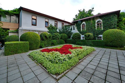 Beautiful decorative flower bed with ornamental pattern in the middle of the hotel complex