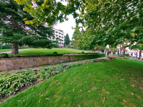 park area with alleys and a cropped lawn in front of the new beautiful houses