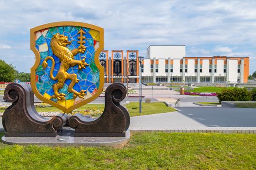 the emblem of the city with a golden lion on the square near the house