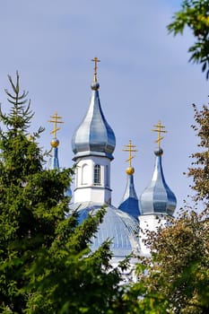 hot cloudless sky and crosses of church shining domes