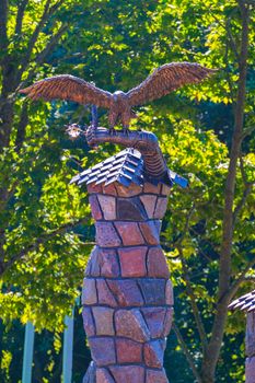 beautiful statue of a metal eagle on a stone fireplace in the house