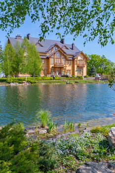 Luxurious house on the shore of a clean lake with birches around. Live in such a continuous gift