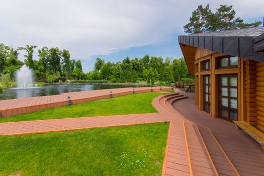 a wooden house with a spacious terrace overlooking the lake with fountains. Mezhigirya. Ukraine