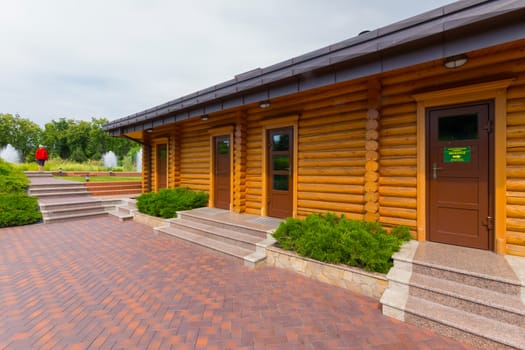elegantly made neat building of logs and an ideally paved area in front of him
