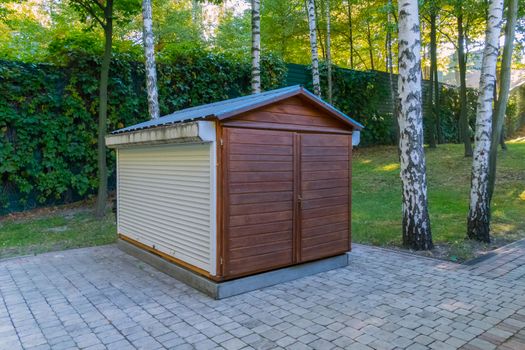 a small utility room near the track in the park under the birches