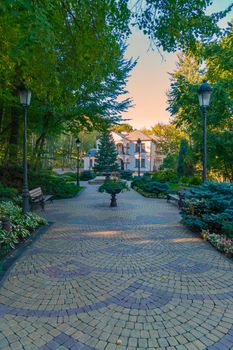 beautiful alley lined with stone leading to the house in the distance