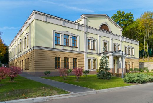 Two-colored, two-story building. One floor is coffee, the second is green. And the windows are high