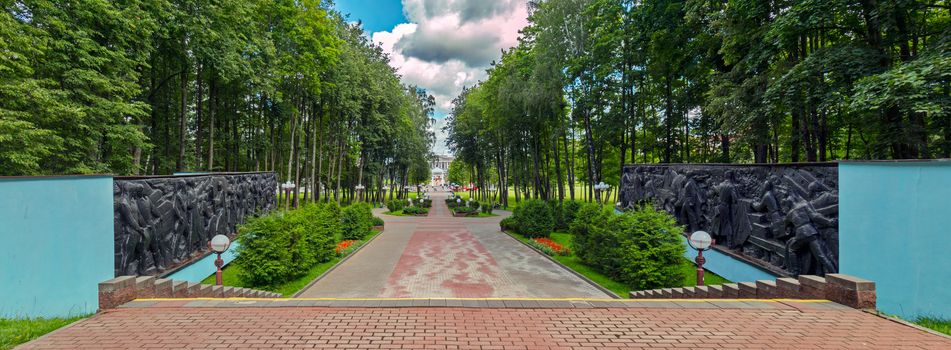 landscaped alley to the exit from the park with decorated walls near the stairs