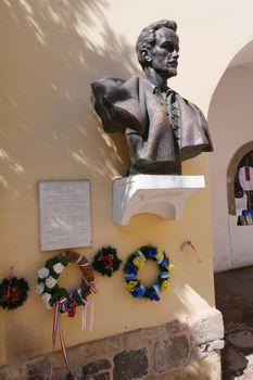 The monument on the wall of Shandor Petofi in the Mukacheve castle is decorated with flower wreaths