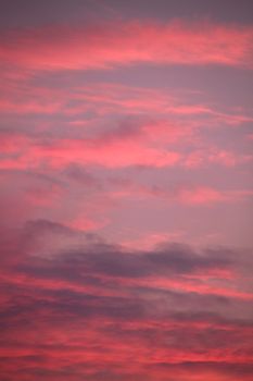 A picturesque purple sunset against a background of small clouds