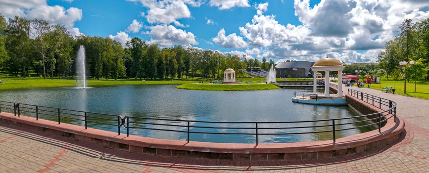 Priozernaya park walking area with beautiful alleys against the background of green trees