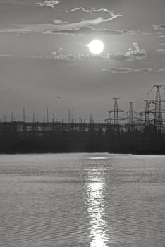 The lunar path on the water surface stretching to the construction in the distance