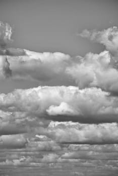 The gray sky is completely covered with dense clouds without the slightest clearance in which one can see the sun stretching away to the horizon line.