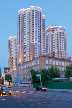 three high-rise new buildings with evening illumination