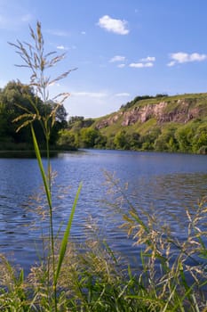 Beautiful blue deep lake on a background of green rocky mountains