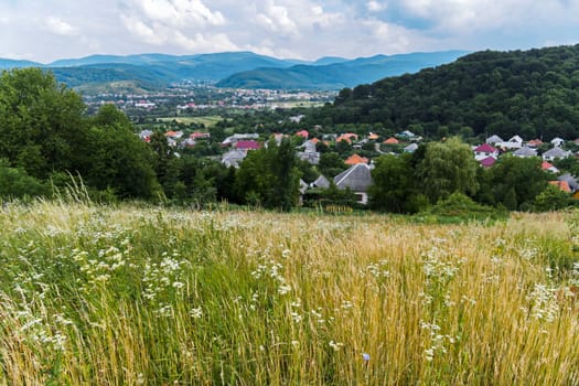 he village lying in the green mountain valley is very beautiful