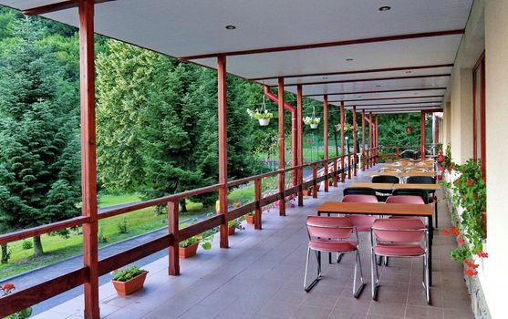 Summer terrace with tables and chairs with a beautiful view of the picturesque nature
