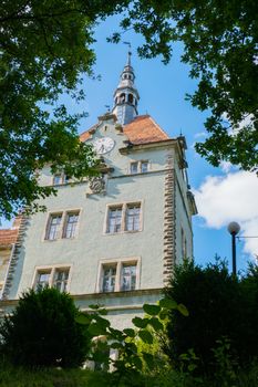 the spire of the Schonborn castle rises high among the beautiful green park. Carpathians. Ukraine