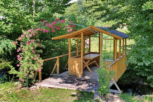A beautiful wooden gazebo in the garden, for cozy summer farmhouses in the evening for a bottle of beer or a glass of wine