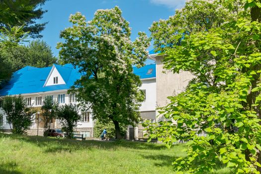A beautiful modern sanatorium with a blue roof standing in a good place with picturesque nature