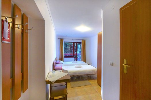 Double room in the hotel with a modern renovation and a beautiful view opening from the balcony to the beautiful nature around.