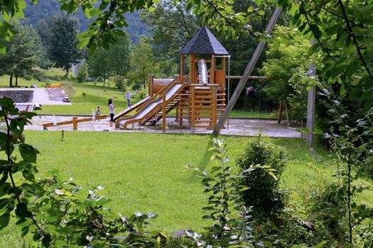 a playground with a beautiful wooden playground and a slide for descent