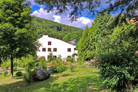 country house in the Carpathians against the background of a coniferous forest