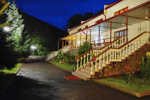 A magnificent hand-embroidered picture depicting a beautiful house with a terrace and two stairs with steps at night with lanterns burning among the trees on the lawn and beautiful flowers.