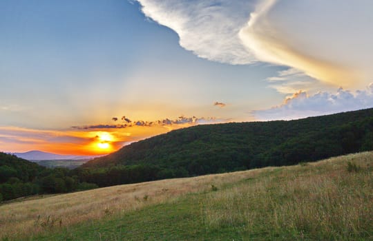 the beauty of a heavenly sunset against the backdrop of magnificent mountains