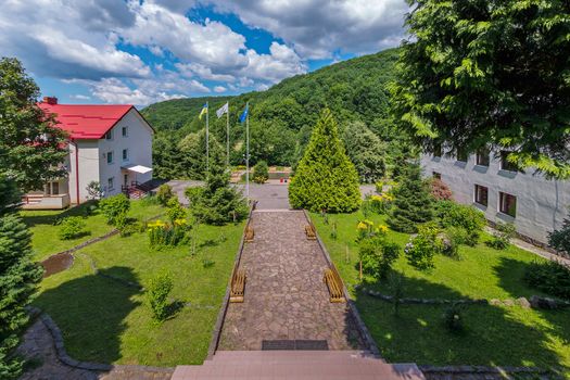 a path of stone slabs with benches in the Carpathians