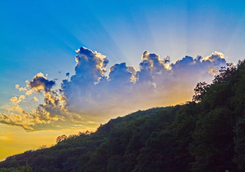 sunrise and beautiful blue-gray clouds on the background of the mountain