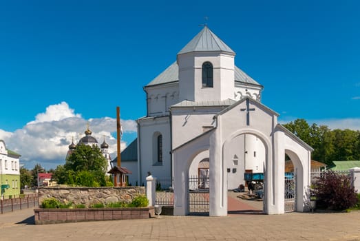 A small white church with a temple and a blue clear sky