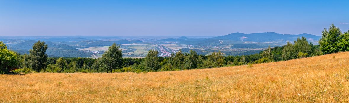 delightful panorama from the yellow slope to the city lying in a mountain valley