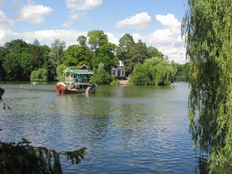 river tram with colorful flags on the background of dense greenery