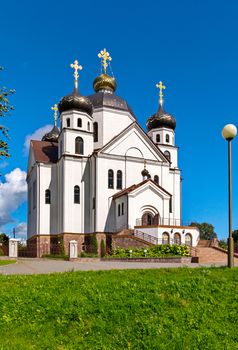 cathedral against a bright blue sky and a green lawn