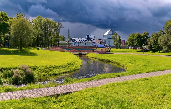 A small river canal with clear water against the background of church buildings