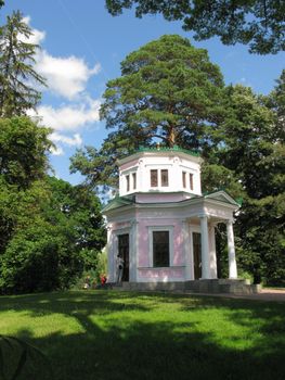 A small neat chapel with white walls located on a green hillock