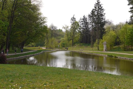 People stroll along the packed avenues amidst a beautiful transparent lake