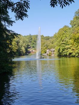 Highly beating fountain, straight as a geyser. Installed directly in a small lake