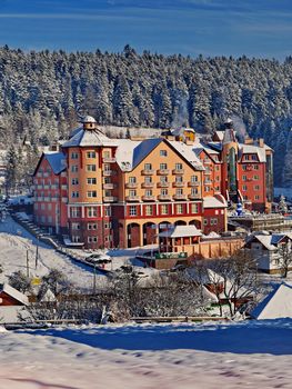 Large, multi-storey residential complex in winter. Around everything in the snow