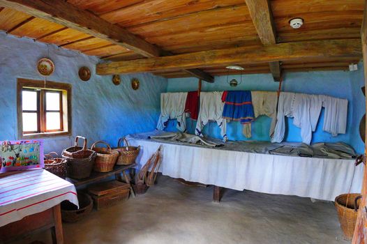 room in an old house with wicker baskets and household utensils