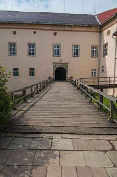 Wooden bridge with railing to the arch of the entrance to the castle. Transcarpathia Uzhhorod Ukraine