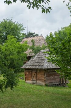 an old wooden stables in the courtyard near the same house, covered with a reed roof in the museum of folk architecture and everyday life. Uzhhorod Ukraine