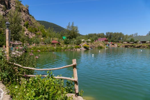 a small pond for recreation located in a picturesque area near the mountains