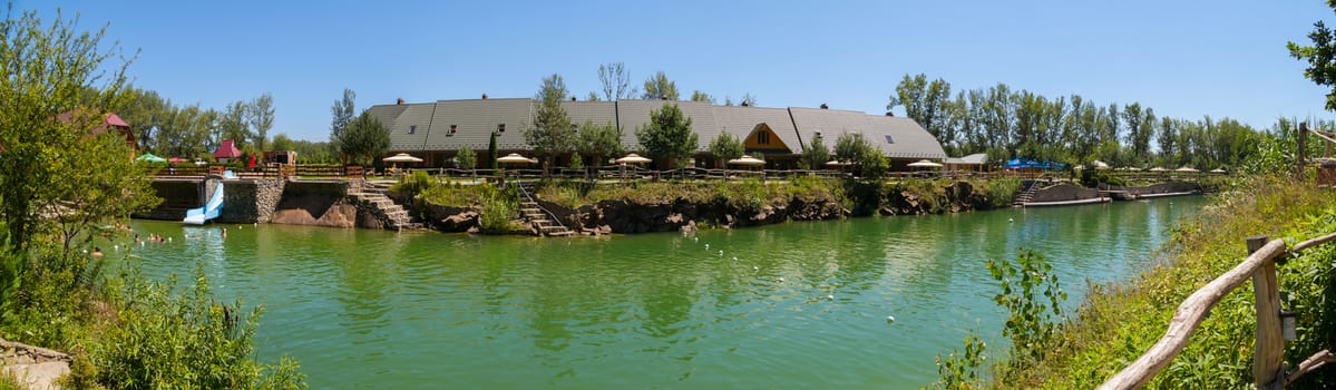 Scenic view of the beautiful transparent lake against the backdrop of the hotel complex