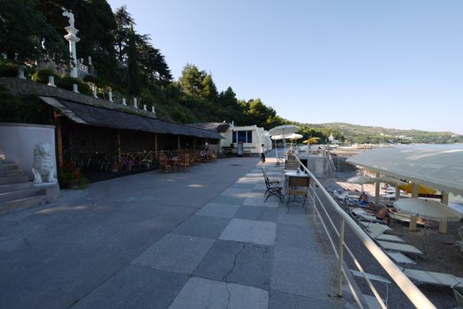 Restaurant on the seafront. Closer to the water are trestles and umbrellas for holidaymakers