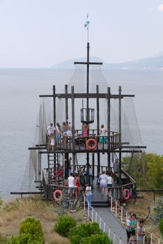 Observation platform with a huge number of tourists in the form of masts of the ship